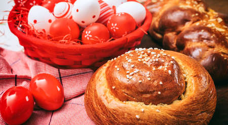 Easter greek tsoureki and eggs on wooden backgroundの写真素材
