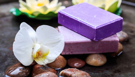 Lavender soap and orchid in water background