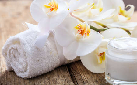 Moisturizing cream and white orchid on wooden backgroundの写真素材