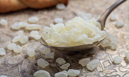 Chios mastic tears in a spoon on a silver backgroundの写真素材