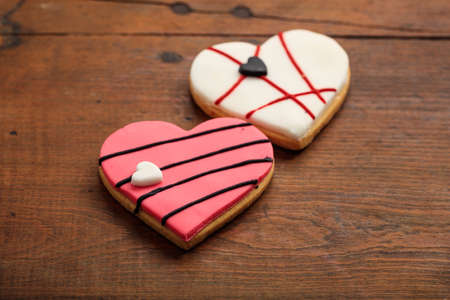 Two heart shaped biscuits on wooden backgroundの写真素材