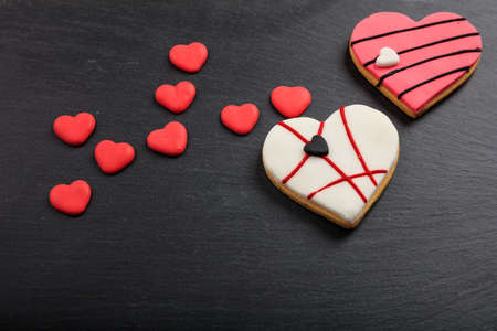 Heart shaped biscuits on a black background with copy spaceの写真素材