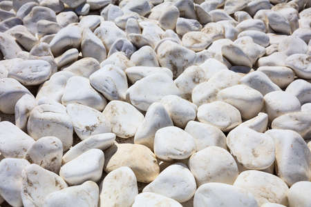 White large pebbles piled on a roofの写真素材