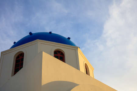 Santorini, Greece - White church with blue dome on sky backgroundの写真素材