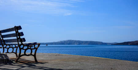 Santorini island, Greece - Wooden bench at Fira old portの写真素材