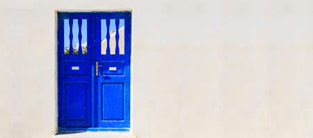 Blue door on a whitewashed wall - Santorini, Greeceの写真素材