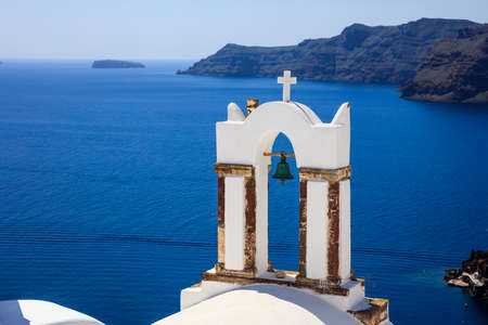 Santorini, Greece - Bell tower and caldera viewの写真素材