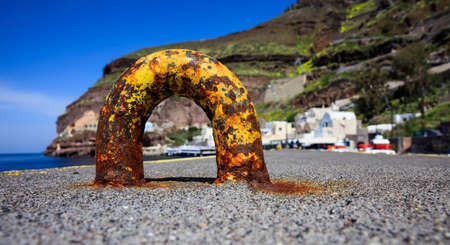 Santorini island, Greece - Rusty mooring at Fira old portの写真素材
