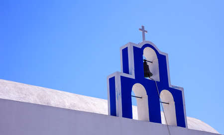 Santorini, Greece - Bell tower on blue sky backgroundの写真素材