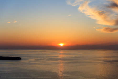Beautiful sunset over Aegean sea at Santorini island Greeceの写真素材
