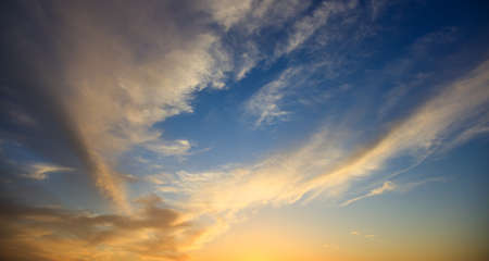 Blue sky with some clouds at sunsetの写真素材