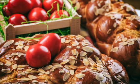Easter traditional bread and red eggs on a table