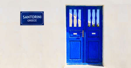 Blue door on a whitewashed wall - Santorini island, Greeceの写真素材