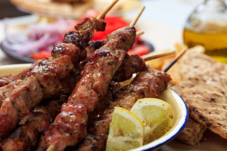 Grilled meat skewers and pita bread in a dishの写真素材