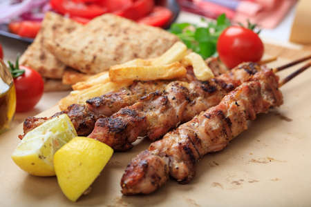 Grilled meat skewers on a baking paperの写真素材