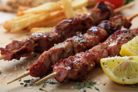 Grilled meat skewers on a baking paperの写真素材