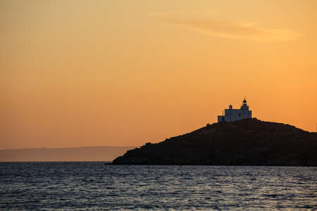 Greece, Kea island. Lighthouse on a cape at sunsetの写真素材