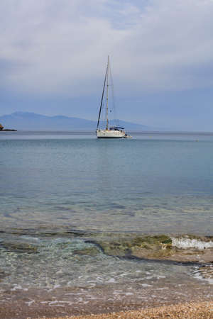 Sailing boat on a blue sea and sky backgroundの写真素材