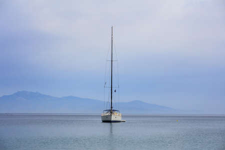 Sailing boat on a blue sea and sky background