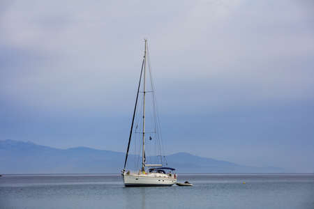 Sailing boat on a blue sea and sky backgroundの写真素材