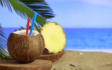 Summer vacations concept - Sandy beach and coconut drinkの写真素材