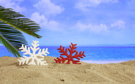 Christmas ornaments on a sandy beach - copy spaceの写真素材