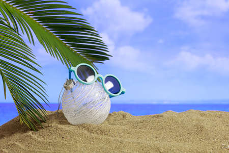 Christmas ball on a sandy beach - copy spaceの写真素材