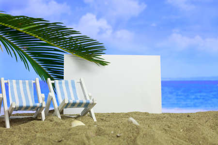 Summer vacations concept - Deckchairs on a sandy beach - blank cardの写真素材