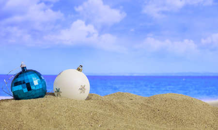 Christmas balls on a sandy beach - copy spaceの写真素材