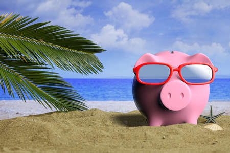 Summer, low budget, holidays - Piggy bank on a sandy beach. 3d illustrationの写真素材