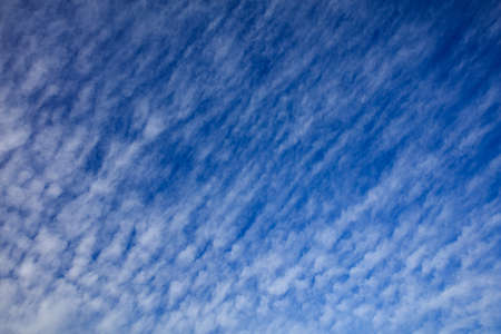 A few clouds on a blue sky backgroundの写真素材