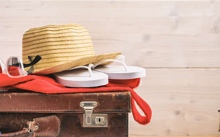 Beach accessories on an old suitcase - white wooden background - copy spaceの写真素材
