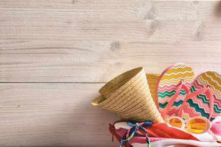 Summer beach bag and accessories on white wooden background - copy spaceの写真素材