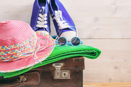 Beach accessories on an old suitcase - white wooden background - copy spaceの写真素材