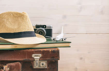Travel accessories on an old suitcase - white wooden background - copy spaceの写真素材