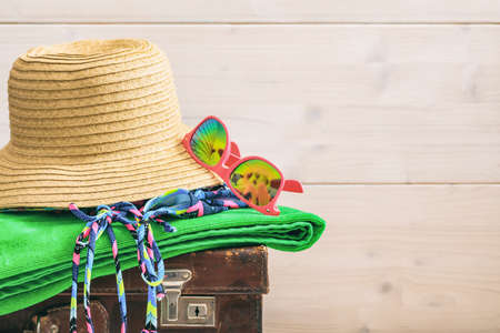 Beach accessories on an old suitcase - white wooden background - copy spaceの写真素材