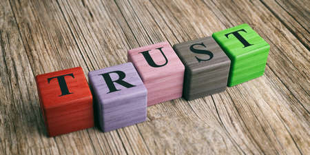 Word Trust on wooden blocks and wooden background. 3d illustrationの写真素材