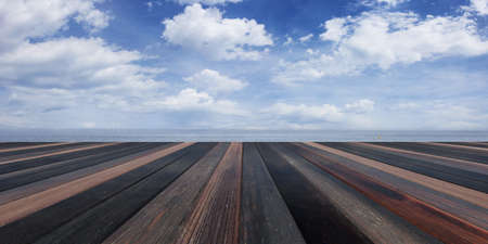 Wooden planks on blue cloudy sky background and copy space. 3d illustrationの写真素材