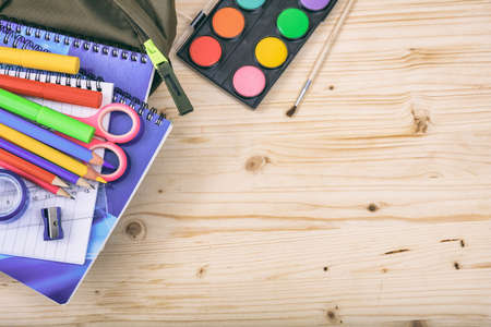 School supplies on wooden background - space for caption