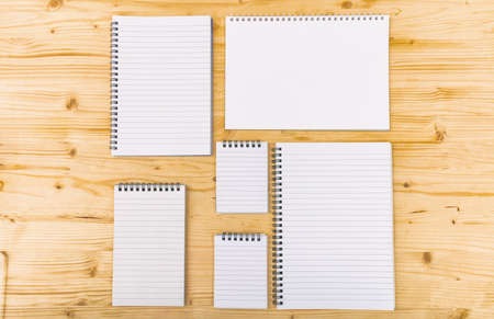 Variety of notebooks on wooden backgroundの写真素材