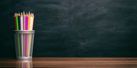 School concept - Colored pencils on a black chalkboard background. 3d illustrationの写真素材