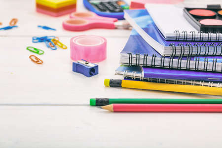 Variety of school - office supplies on wooden background