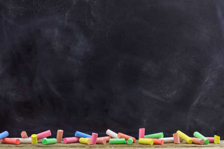 School concept - Colorful chalks and a blackboardの写真素材
