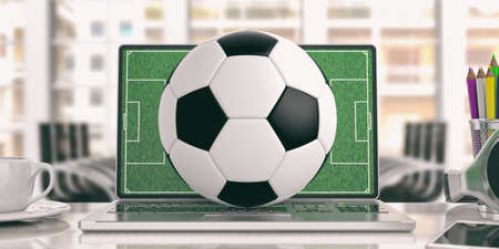 Soccer ball on a laptop - office background. 3d illustrationの写真素材