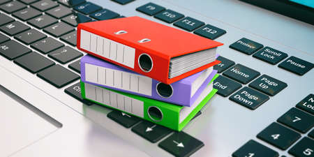 Colorful ring binders on a laptop keyboard. 3d illustrationの写真素材