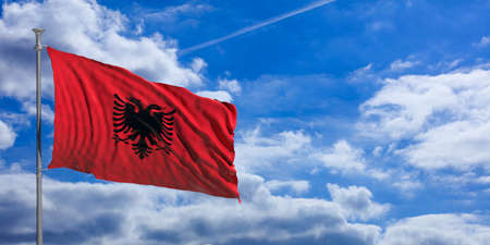 Albania flag waving on a blue sky background. 3d illustrationの写真素材