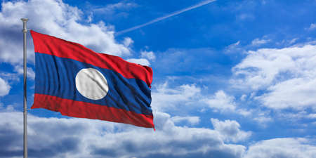 Laos waving flag on blue sky background. 3d illustrationの写真素材