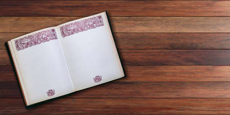 Open old book on wooden planks background - copy space