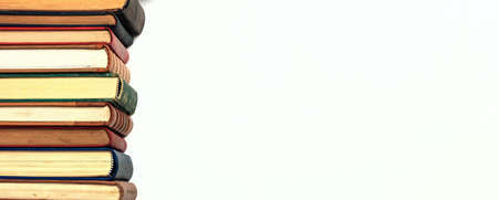 Old books stacked on white background - copy spaceの写真素材