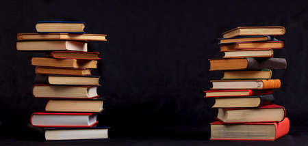 Old books stacked on black backgroundの写真素材